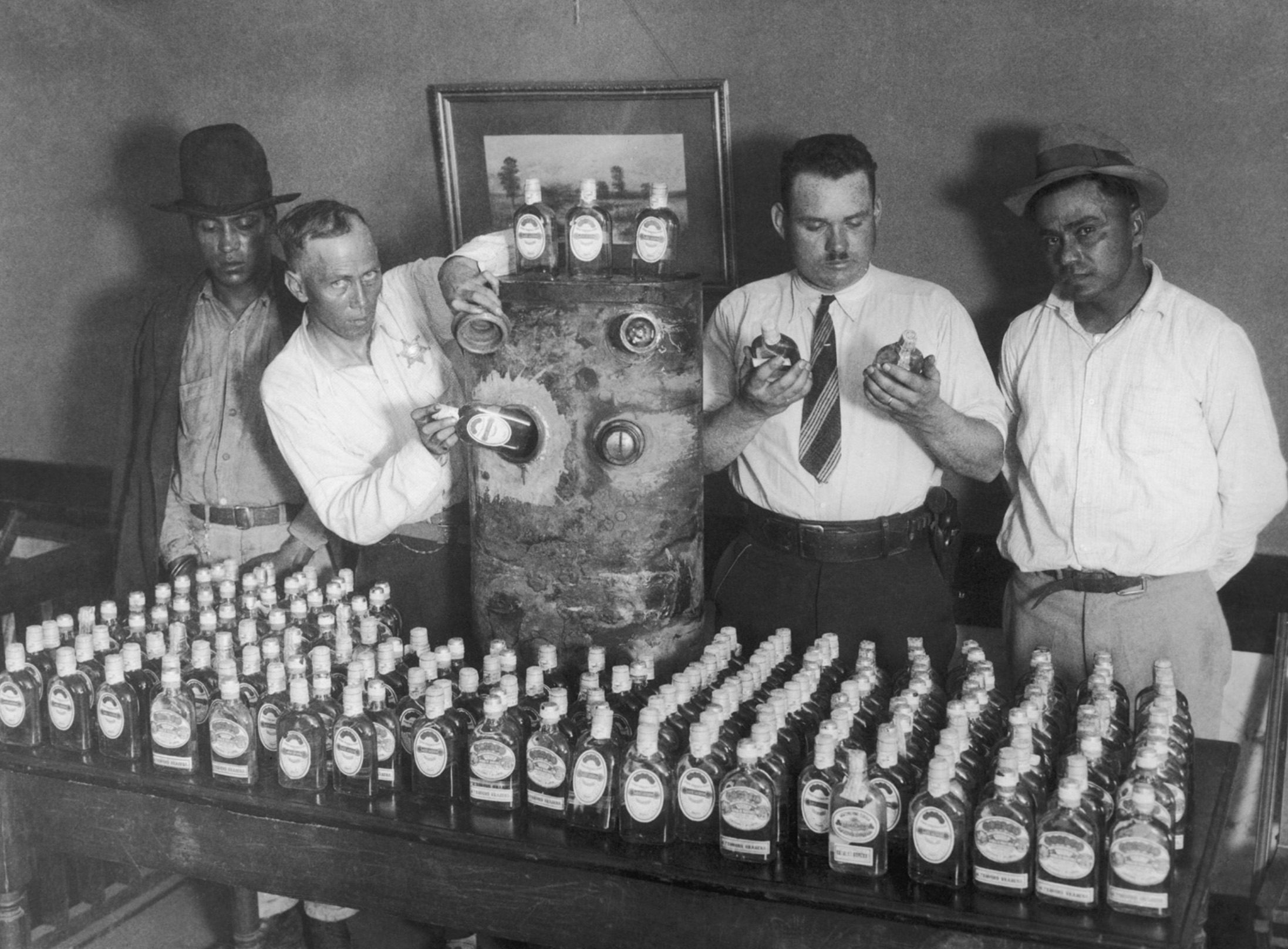 California prohibition agents confiscating a fuel tank with 250 bottles of tequila hidden in it 